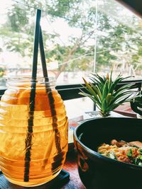 Close-up of food and peach tea served on table at restaurant