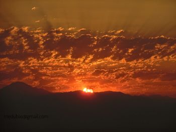 Scenic view of silhouette mountain against sky during sunset