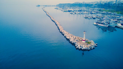 High angle view of a port with moored boats and a lighthouse