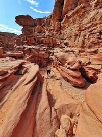 High angle view of shirtless man standing by rock formation