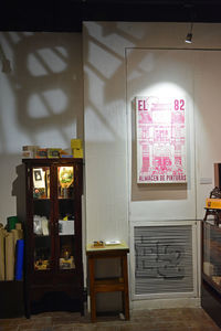 Empty chairs and tables in illuminated house