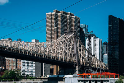 Low angle view of modern buildings against blue sky