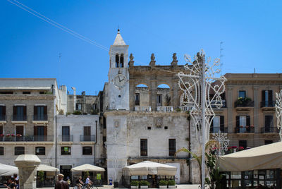 Low angle view of buildings against blue sky