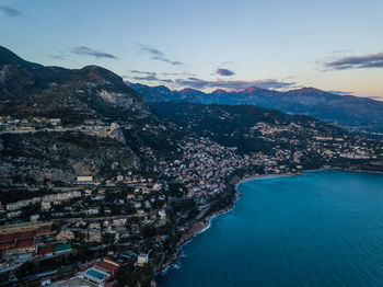 High angle view of sea and mountains against sky