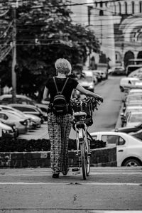 Woman riding bicycle on city street