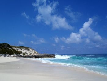 View of beach against cloudy sky