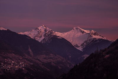 Scenic view of snowcapped mountains against sky during sunset