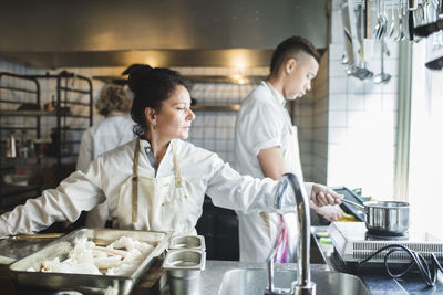 People having food in kitchen