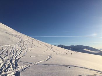 Scenic view of mountains against clear blue sky