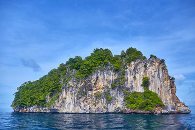 Scenic view of island amidst sea against sky