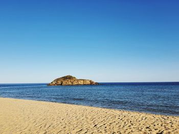Scenic view of sea against clear blue sky