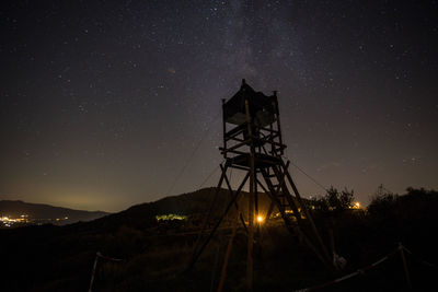 Low angle view of silhouette tower against sky at night