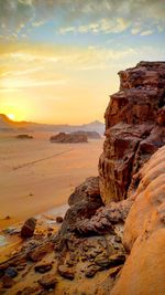 Scenic view of rock formations against sky during sunset