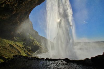 Scenic view of waterfall from behind