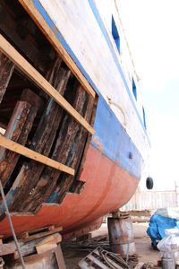 Boats moored in water against sky