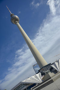 Low angle view of communications tower against sky