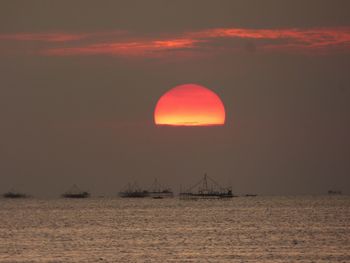View of sea against cloudy sky during sunset