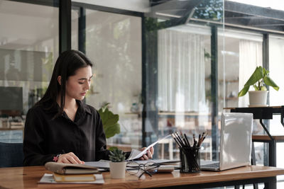 Young businesswoman working at office