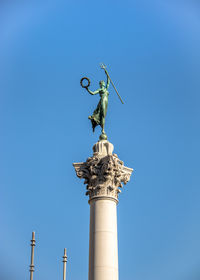 Low angle view of statue against clear blue sky