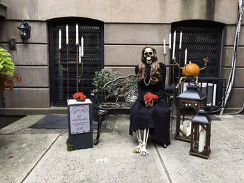 Halloween decorations of a widow skeleton, pumpkin, and tombstone