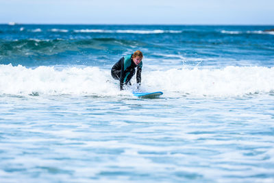 Person in sea against sky