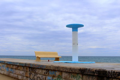 Lifeguard hut by sea against sky