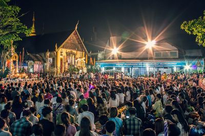 Crowd at illuminated temple during festival at night