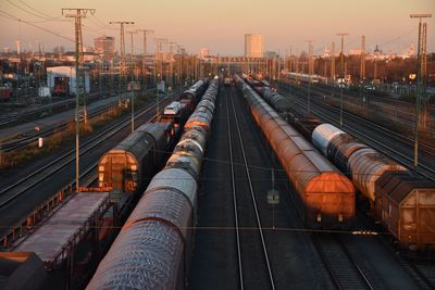 High angle view of freight trains at shunting yard during sunset