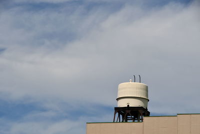 Low angle view of communications tower against sky