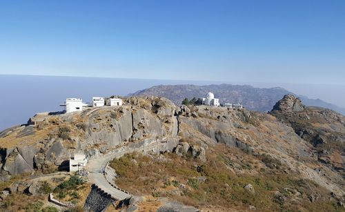 View of mountain range against clear blue sky