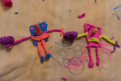 High angle view of multi colored toys on sand