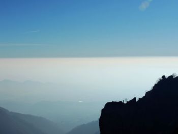 Scenic view of silhouette mountains against sky