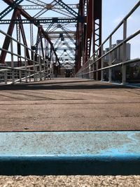 Surface level of bridge against sky in city