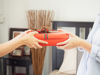 Midsection of woman holding red wine