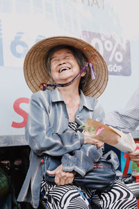 Portrait of smiling woman wearing hat