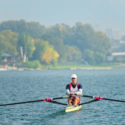 People rowing boat in water