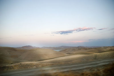 Scenic view of desert against sky during sunset