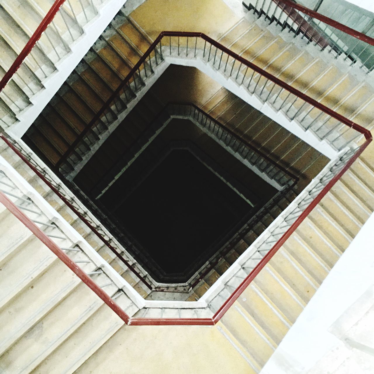 steps and staircases, indoors, steps, staircase, architecture, built structure, railing, ceiling, low angle view, the way forward, diminishing perspective, spiral staircase, pattern, stairs, directly below, building, vanishing point, high angle view, no people, spiral