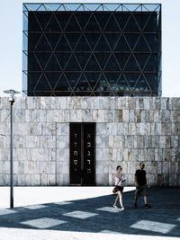 People walking in front of building