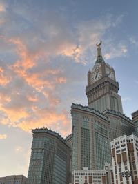 Low angle view of zam zam tower facing against the pink sunset sky