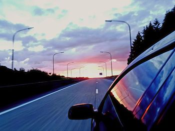 Cars on street against sky