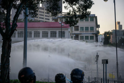People on street against buildings in city