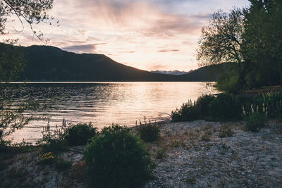 Scenic view of lake against sky during sunset