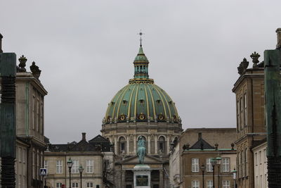 Low angle view of buildings against sky in city