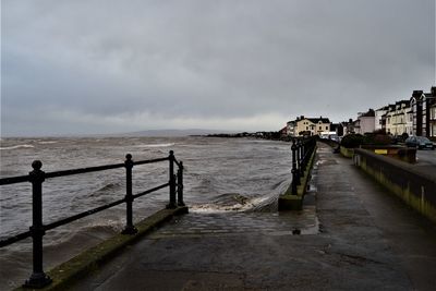 Scenic view of sea by buildings against sky