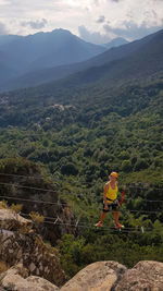 Woman on landscape against mountain range