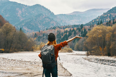 Rear view of man standing on mountain