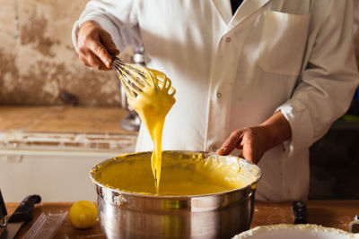 Midsection of man preparing food