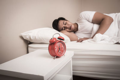 Young woman lying on bed at home