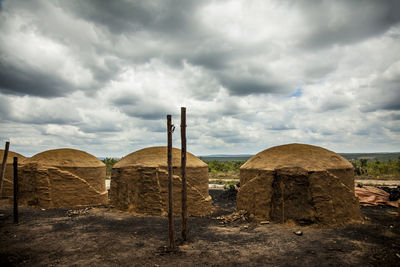 Old ruins on field against sky